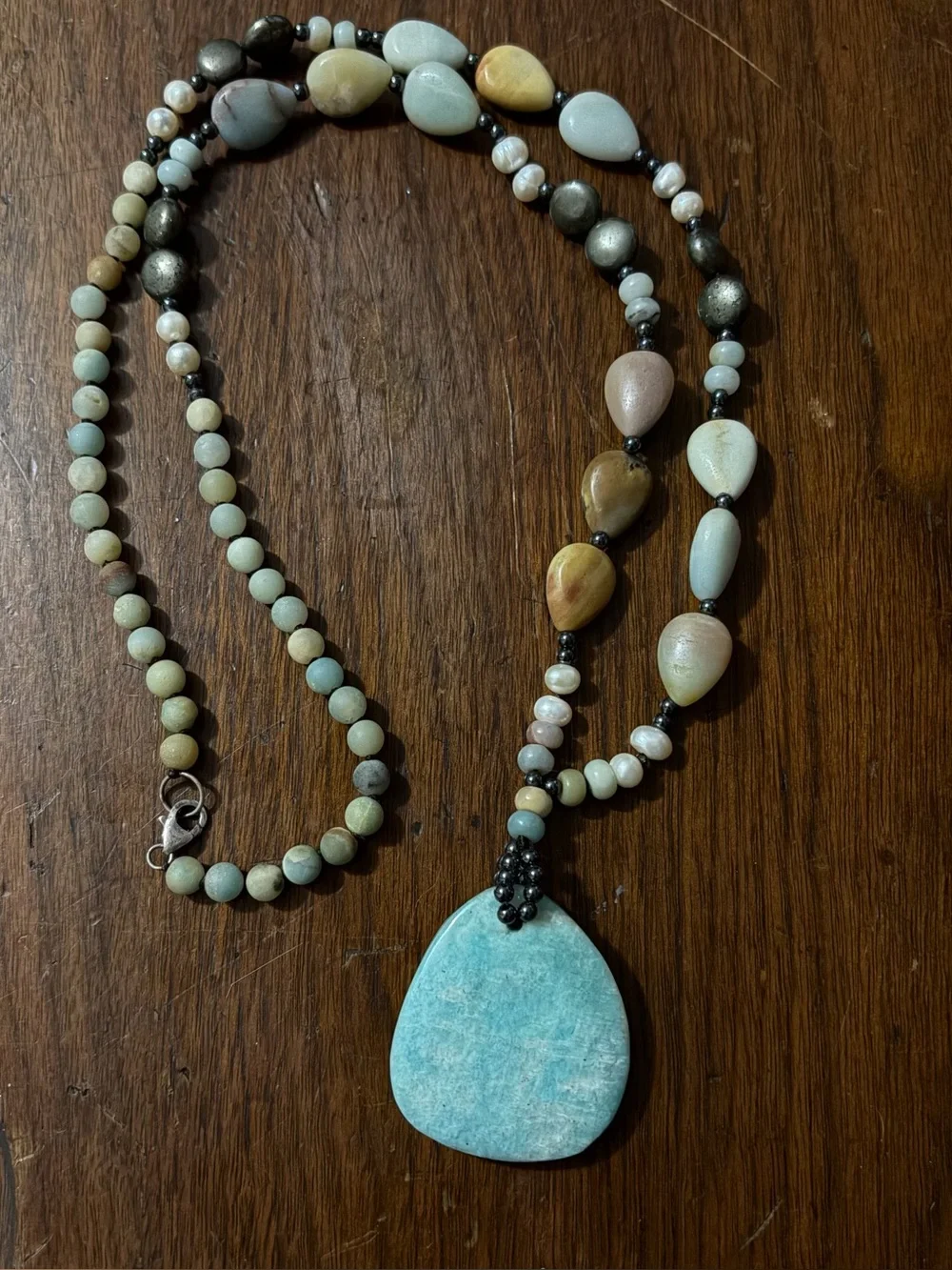 Rare Gemstone with Sterling silver accents on 18” Tear drop necklace